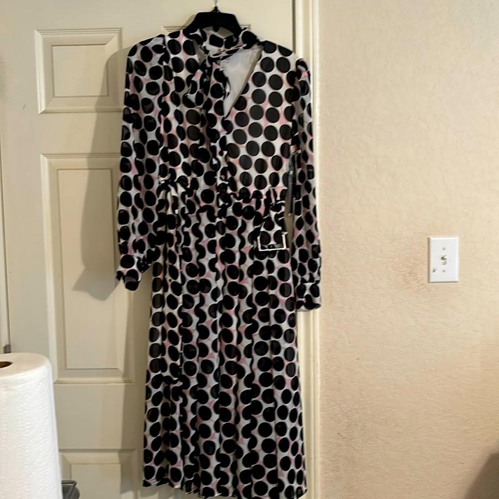 Black polka dots with white  background and shades of pink.
